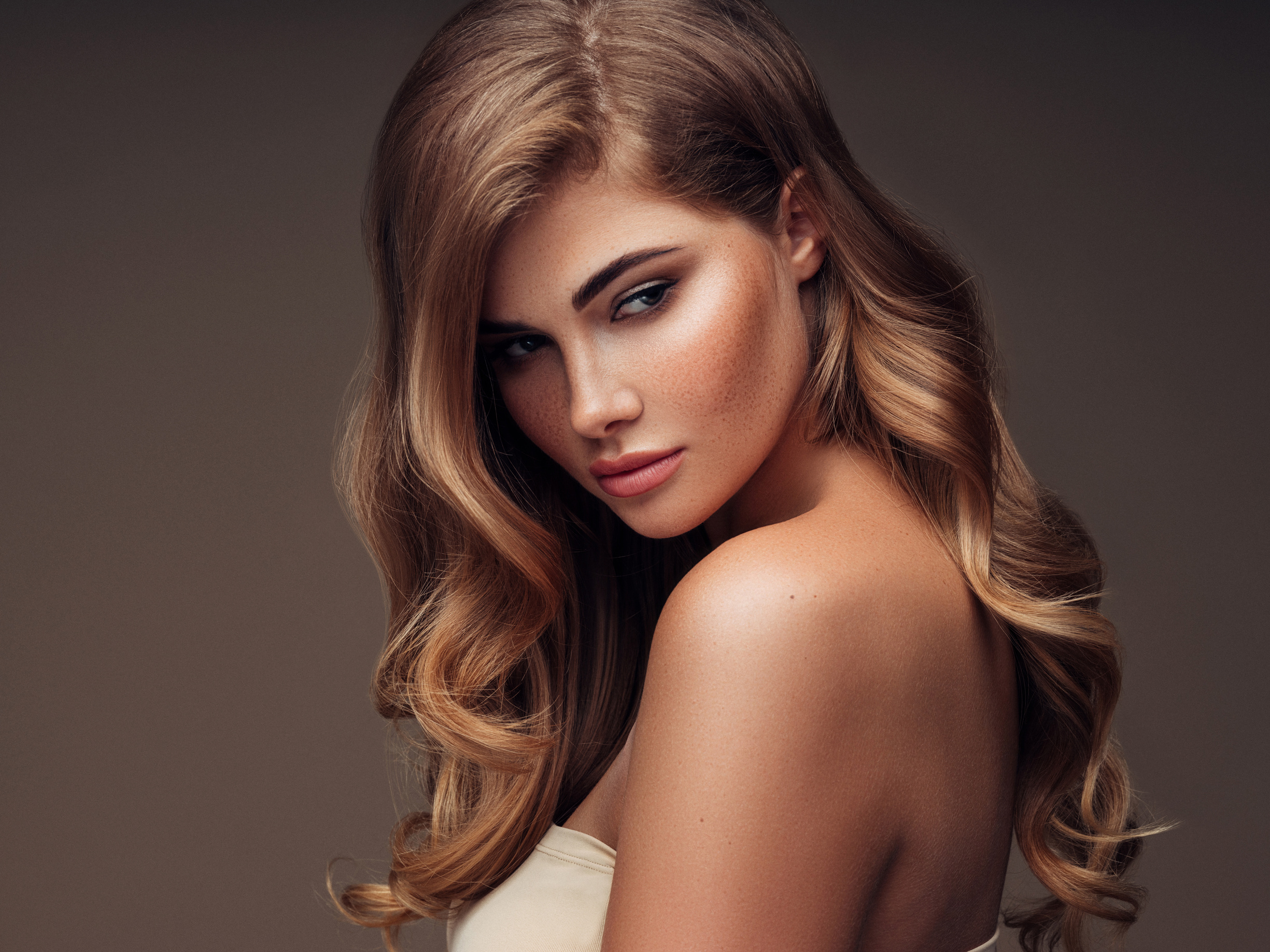 Young beautiful model with long wavy well groomed hair